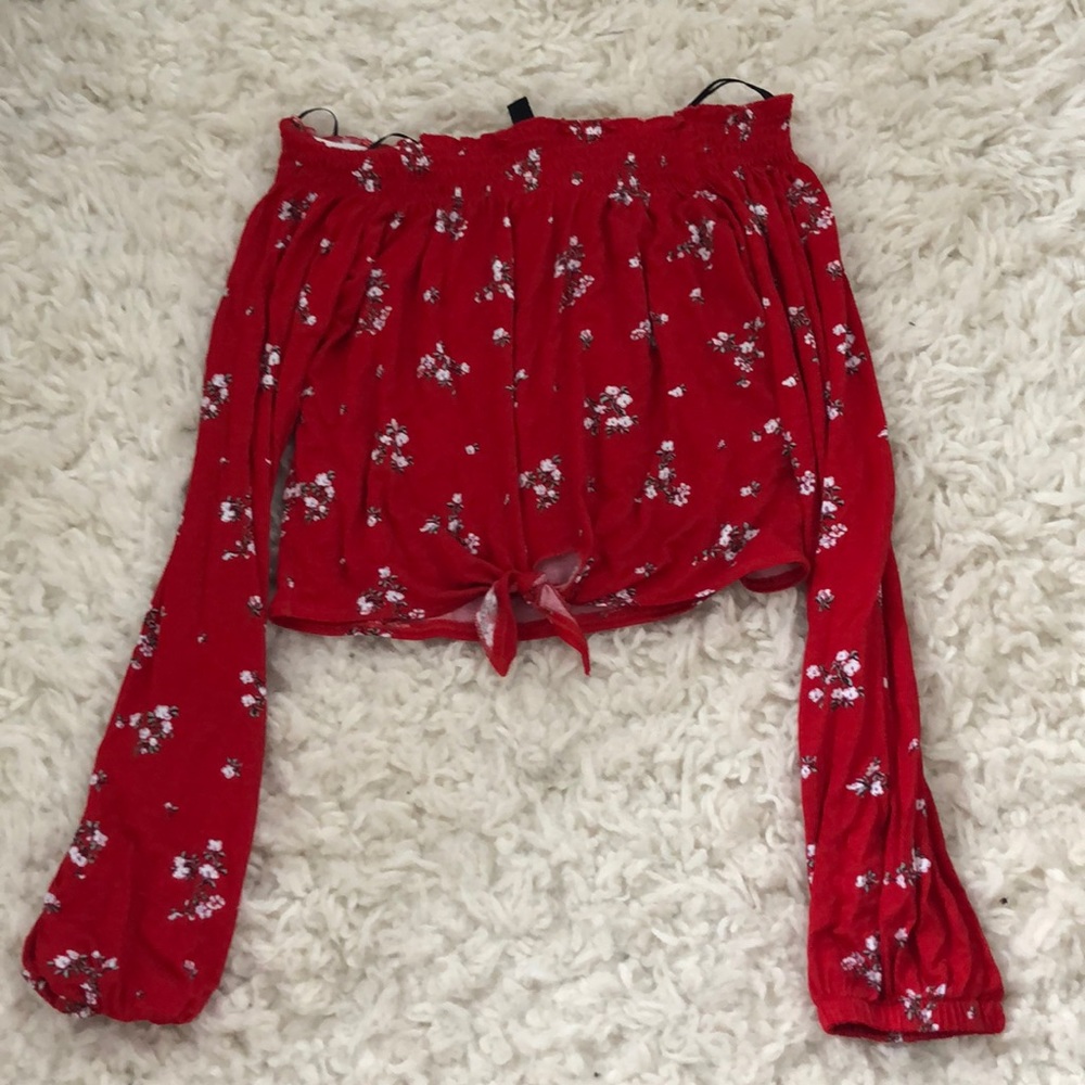 A red cropped long sleeve shirt